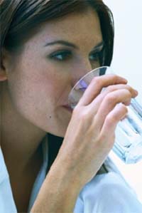 Photo of woman drinking a glass of water